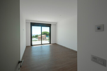 Empty room with large panoramic windows overlooking the sea. Room after major renovation.