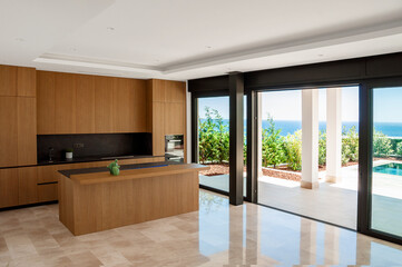 Fototapeta na wymiar Modern kitchen with island in browns.