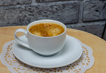 cup of coffee on a white saucer close-up