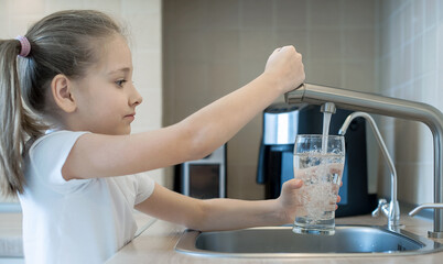 Little child open water tap. Kitchen faucet. Glass of clean water. Pouring fresh drink. Hydration....