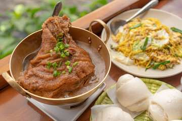 Closed up stewed pork leg with Chinese traditional sweet gravy source and serve with 
mantou