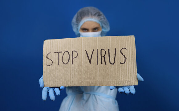 Doctor Woman In Protective Mask Holding Poster Quarantine