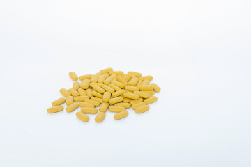 Fototapeta na wymiar yellow pills isolated on white background