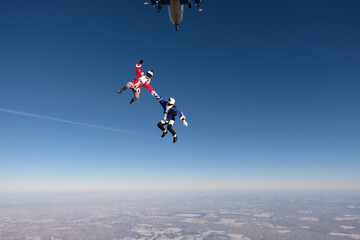 Skydiving. Funny jump. A man and a woman are having fun in the sky.
