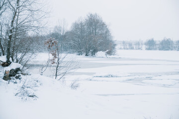 Winter frosty landscape of the river with broken ice