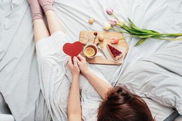 The girl in bed in the morning received flowers, gifts and breakfast in bed. Congratulations on...