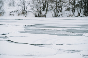 Winter frosty landscape of the river with broken ice