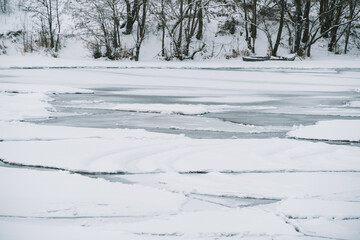 Winter frosty landscape of the river with broken ice