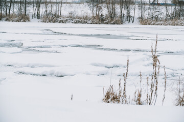 Winter frosty landscape of the river with broken ice