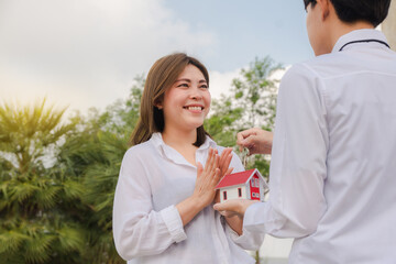 Man giving key house to women happy family concept couple love family business rent sale insurance investment