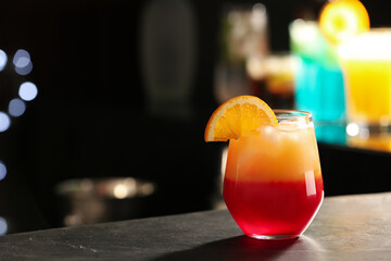 Delicious cocktail with orange on bar counter. Space for text