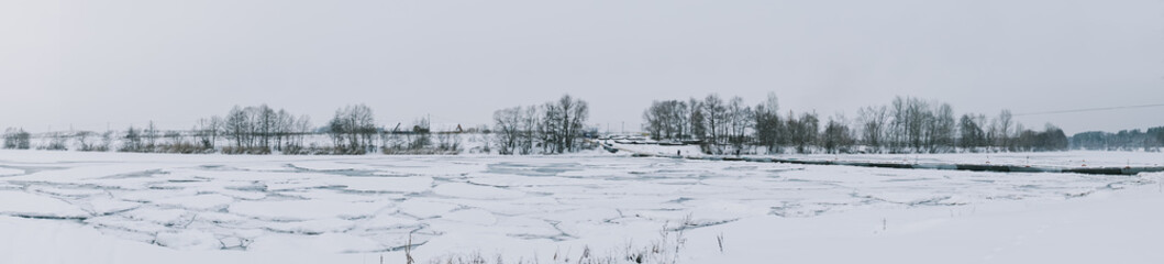 Winter frosty landscape of the river with broken ice