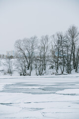 Winter frosty landscape of the river with broken ice