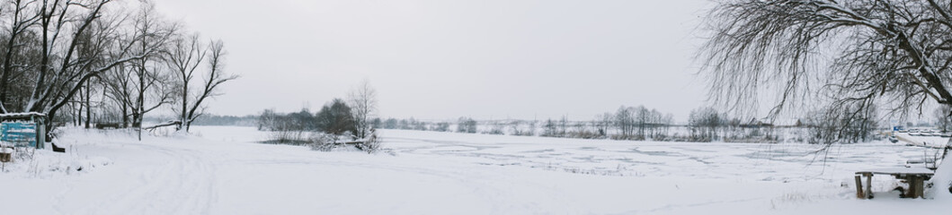 Winter frosty landscape of the river with broken ice