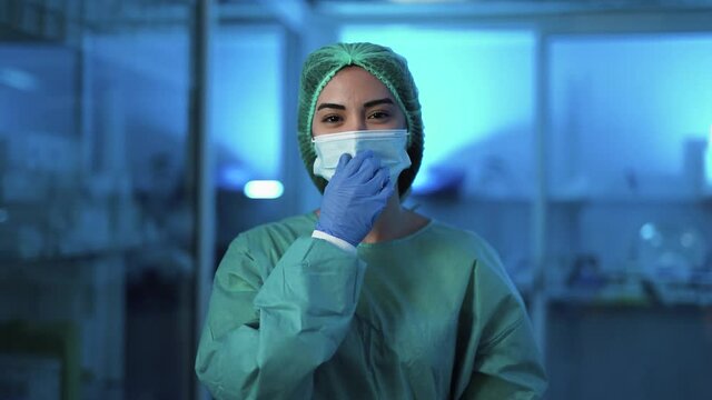 Female Doctor Move Surgical Face Mask And Smiling - Health Care Worker Inside Hospital 