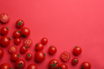 Fresh cherry tomatoes on red background, flat lay. Space for text