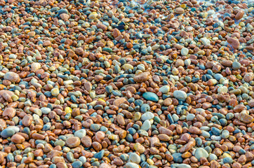 Colored sea pebbles on the beach.