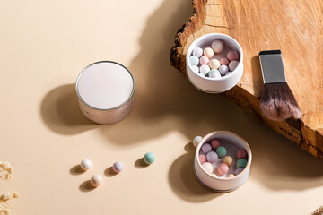 Ball pearl blush, face powder, makeup brush on a beige background. Various cosmetic products, Makeup Accessories.