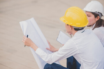 Two people engineer use blueprint talking discussion building civil construction project