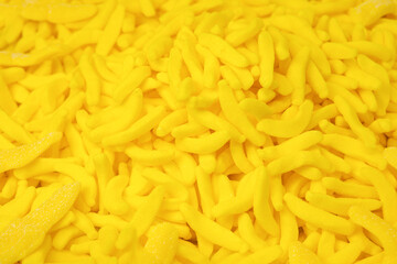 Colorful jelly banana candies close up as a bright joyful background
