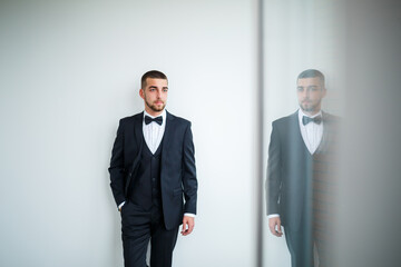 Stylish successful male businessman in a black jacket and with a bow tie
