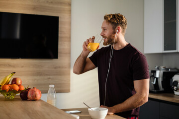 Attractive healthy young man having tasty breakfast