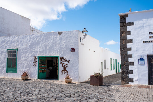 Lanzarote - October 2020: Whitewashed shop typical of Teguise, in Lanzarote, with the figure of the demon from Tierra de Fuego