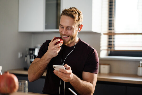 Handsome young man listening to music - Powered by Adobe