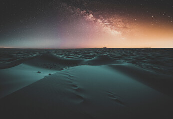 Amazing milky way over the dunes Erg Chebbi in the Sahara desert at Morocco, Africa. Beautiful sand landscape with stunning sky full of stars and night under a starry sky. After sunset. Black desert