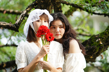 Fototapeta premium Starring girls with red Gerbera