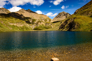 Fanealm und Wilder See in Suedtirol, Italy, Alpine pastures with a deep blue lake, green meadows and a blue sky with fleecy clouds, in summer © Zippl W.