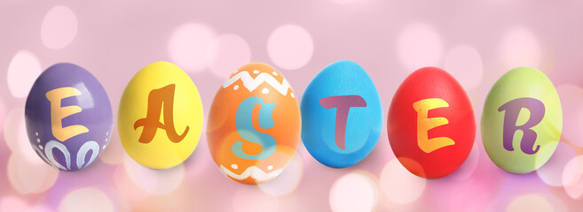Happy Easter. Colorful dyed eggs on pink background, banner design