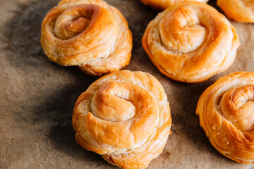 Chelsea buns. Freshly baked rolls buns on a brown background