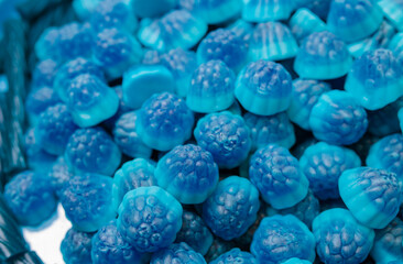 Blue marmalade in the form of blackberries in a pile. lots of blue marmalade background texture