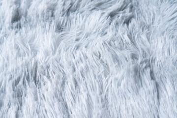 Close up white shaggy artificial fur texture or carpet for background.