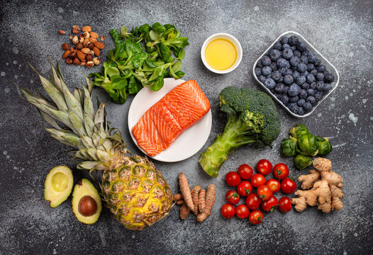 Anti inflammatory diet concept. Set of foods that help to reduce inflammation - plant based ingredients, fresh fruit, green vegetables. Healthy diet products, top view, stone background