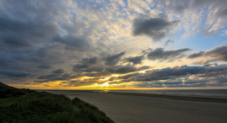 Sunset at Texel beach with light house