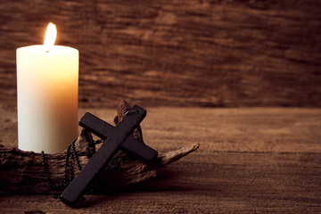 Concept of Christian. close up Jesus Christ black cross on the old wooden table background with...