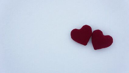 Red hearts on a snow surface