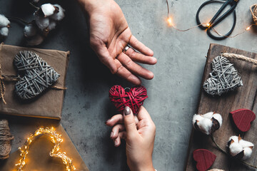 Male hands hold female hands in theirs. Heart in hands. Valentine's Day