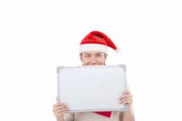 Portrait of young man wearing Santa hat,holding whiteboard