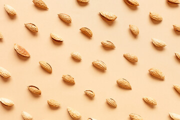 The texture with the walnuts on beige background. Almonds in shell.