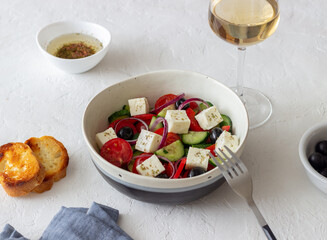 Greek salad with tomatoes, cucumbers, cheese, onions, peppers and olives. Healthy eating. Vegetarian food.