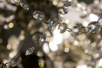 Shining garland of a hanging chandelier on a blurred background