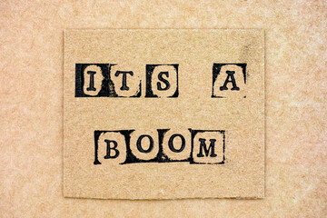 Cardboard with phrase It's a Boom