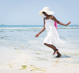 Fototapeta na wymiar Beautiful young black African American woman on the tropical beach