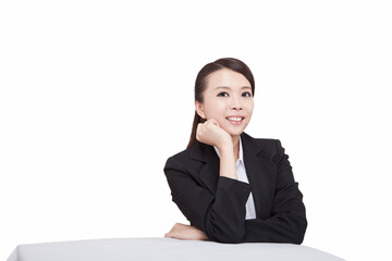 Portrait of young businesswoman sitting at desk,resting head in hand