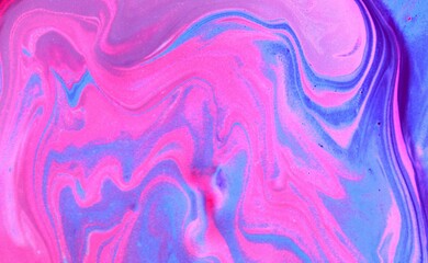 Lilac-pink abstract marble background. The acrylic paint mixes freely and creates an interesting...
