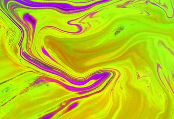 Pink and yellow abstract marble background. The acrylic paint mixes freely and creates an...