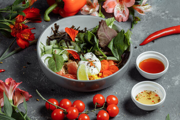 fresh healthy light breakfast, business lunch. Breakfast with poached egg, buckwheat, red fish, fresh salad, cucumbers, business lunch concept